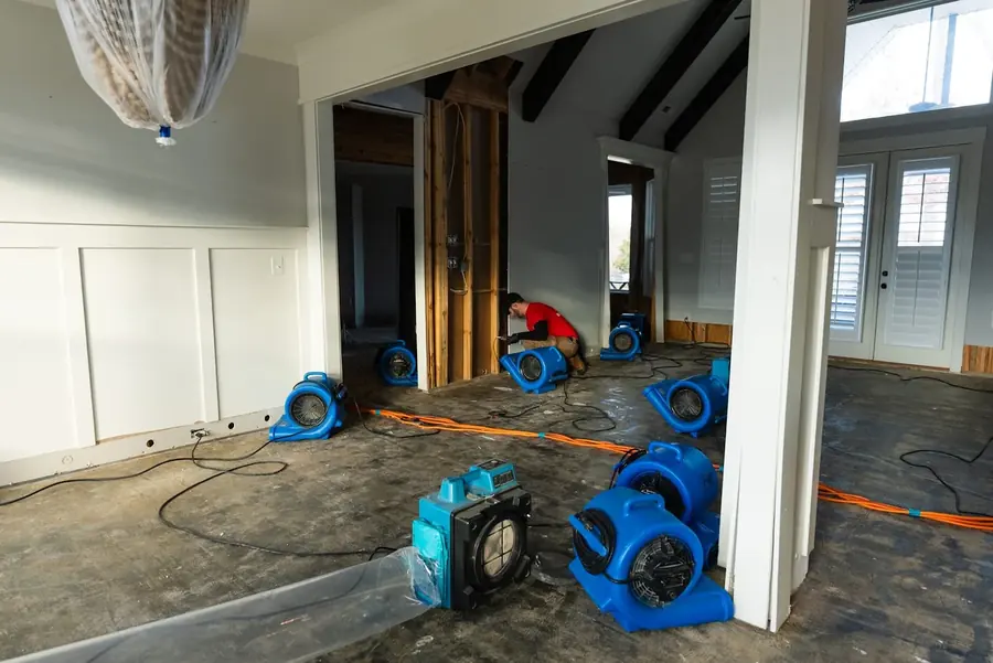 Air movers drying a room after a leak